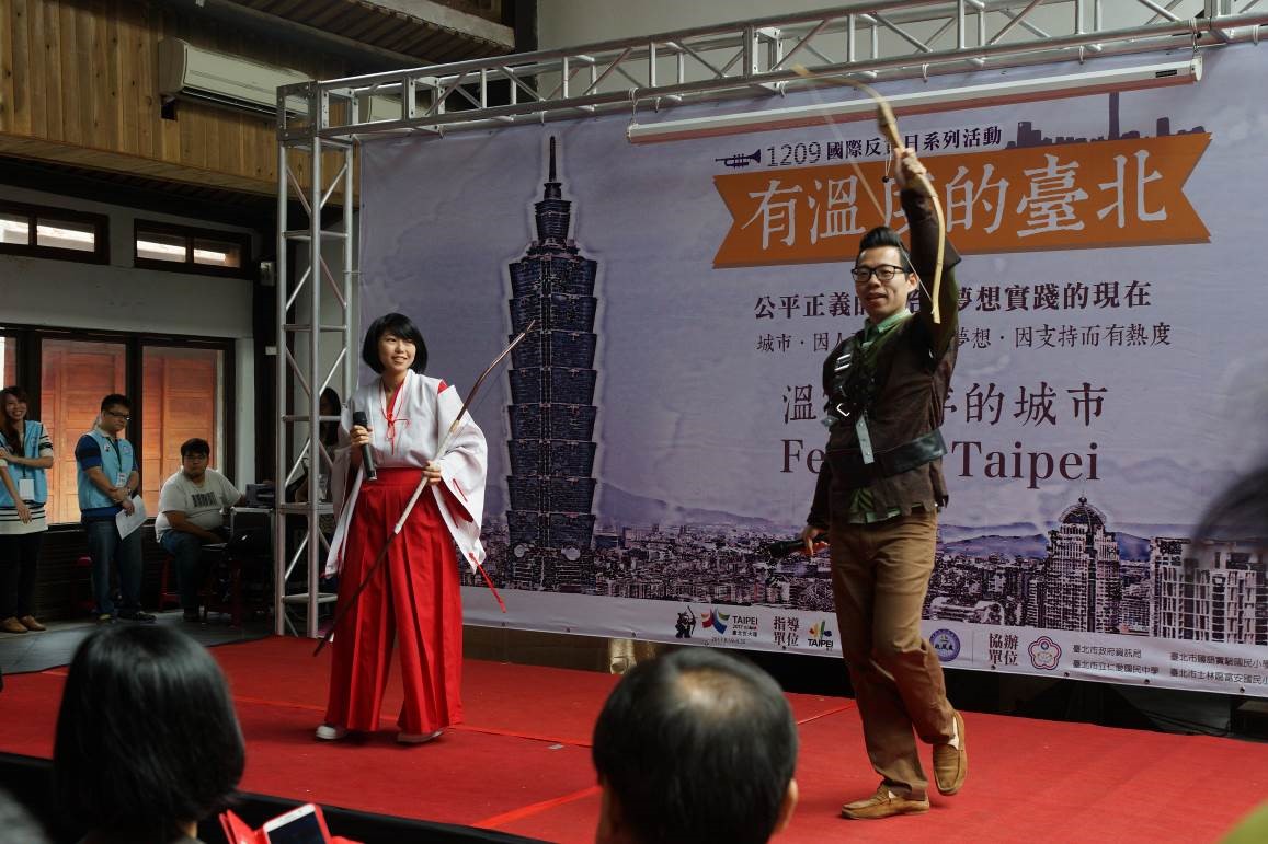 Public Servants from Department of Government Ethics dressed up to be archer Kikyo and Robin Hood, hosting the grand opening.