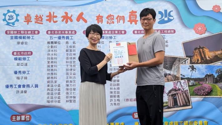 Chang Shun-li, Deputy Commissioner of the Taipei Water Department, presents the Taipei Water Department Labor Day Outstanding Employee Award