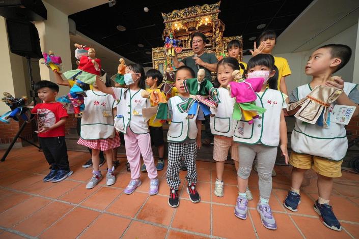 現場觀賞布袋戲演出的孩子體驗操偶