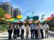 Group photo in front of the floating rainbow umbrella.