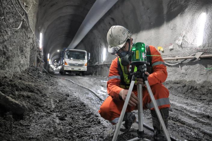 Construction workers measuring and calibrating on-site