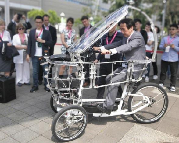 Deputy Mayor Charles Lin trying out the PEV (persuasive electric vehicle) self-driving tricycle