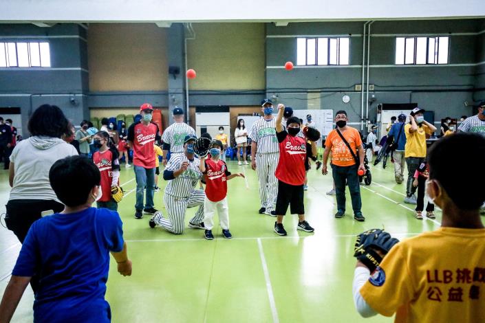 臺北興富發棒球隊球員耐心協助罕見小勇士們進行傳接球訓練。