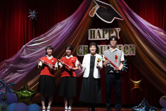 三位學生代表（左起：林以葳、白小櫻、徐定睿）從校長手中接下畢業證書.JPG