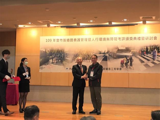 圖1. 內政部陳主任秘書茂春頒發獎座，新工處王副處長健忠代表受獎