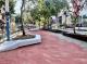 In-progress construction of permeable brick pavement and decorative flower platforms in the central plaza