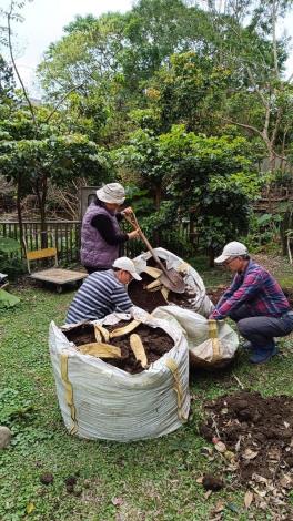 圖2林雍善隊長帶隊，將花卉中心提供腐植土一批批搬運到生態池。