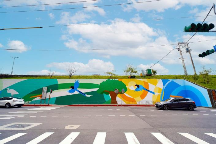 Starting with an orange concentric circle symbolizing the sunrise, the mural expands layer by layer into sky blue