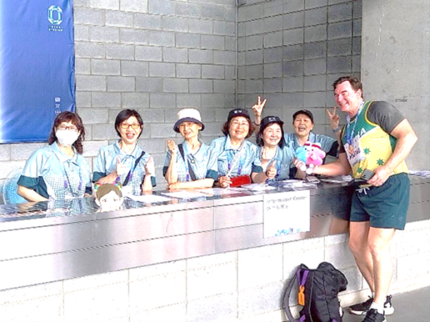 Volunteers take photos with the contestants