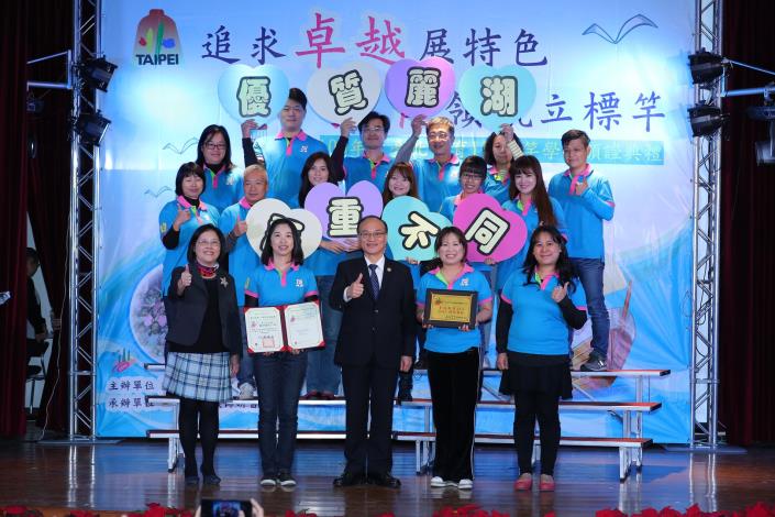 麗湖國小團隊歡喜領取標竿學校證書與獎牌