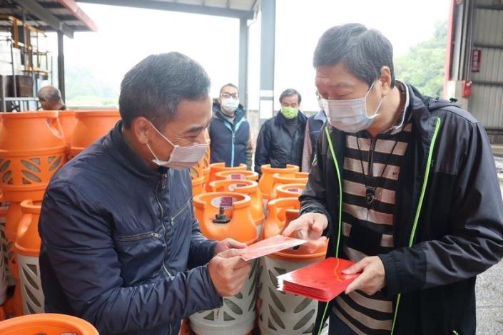 照片4：勞動局長高寶華(右)關懷瓦斯灌裝作業勞工並致贈紅包袋預祝春節快樂。