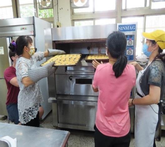 Students learning how to use professional baking equipment