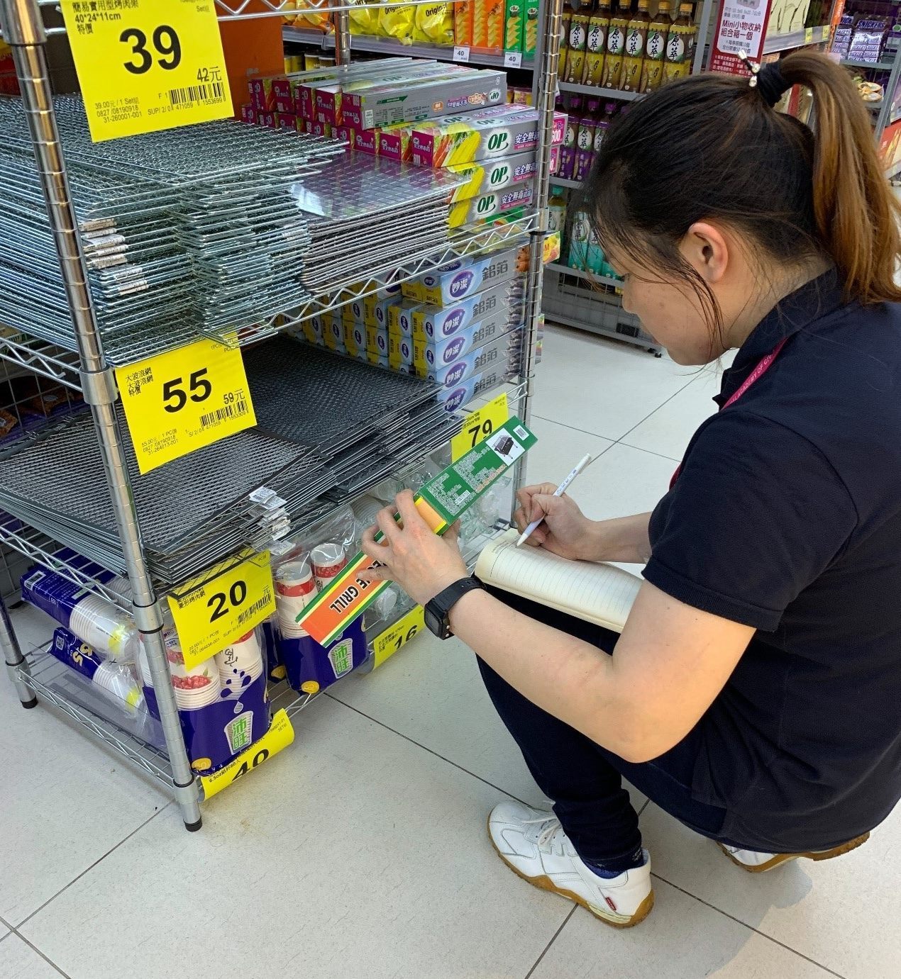 Store staff at big box retailer examining goods used for barbecue