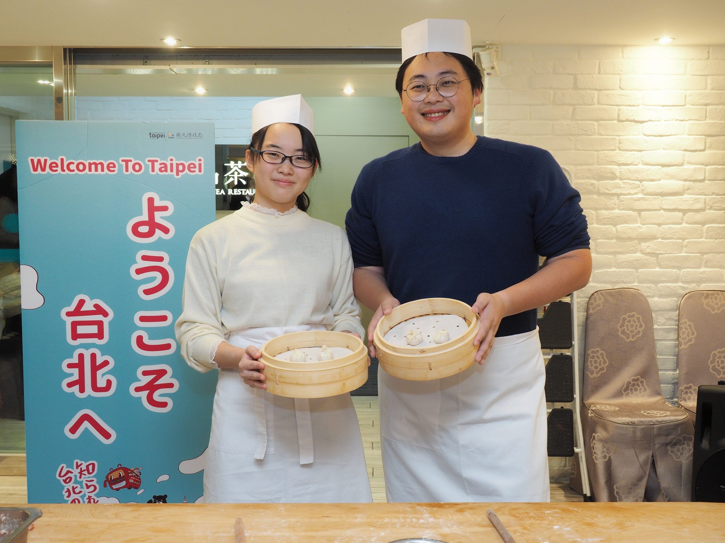 Participants displaying completed steamed dumplings