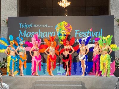 The press conference for Taipei Masskara Festival with individuals wearing smiling masks and extravagant attires
