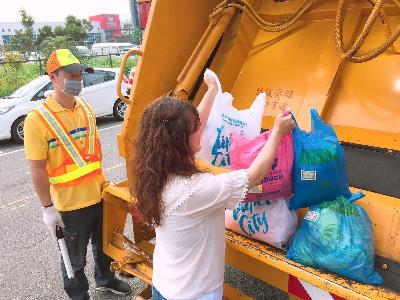 Garbage truck stopping to pick up trash