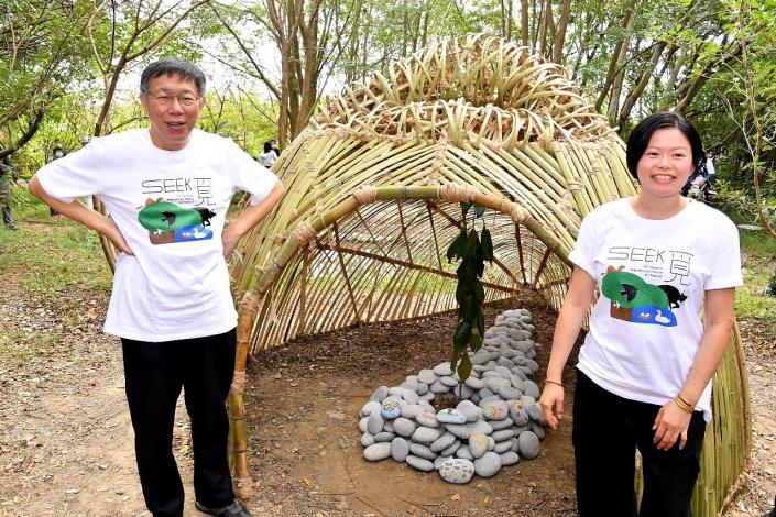 Mayor Ko standing in front of one of the artworks