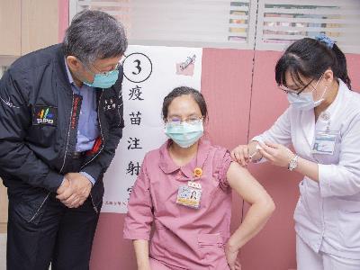 Nurse receiving COVID-19 vaccination
