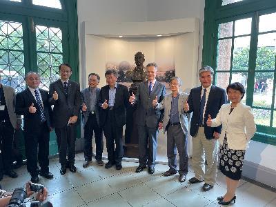 Mayor Ko and dignitaries standing before the bronze bust of Burton.