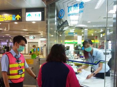 Staff and passenger in front of a MRT information booth