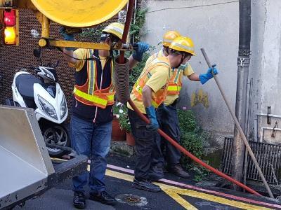 City workers cleaning out gutters ahead of the typhoon.