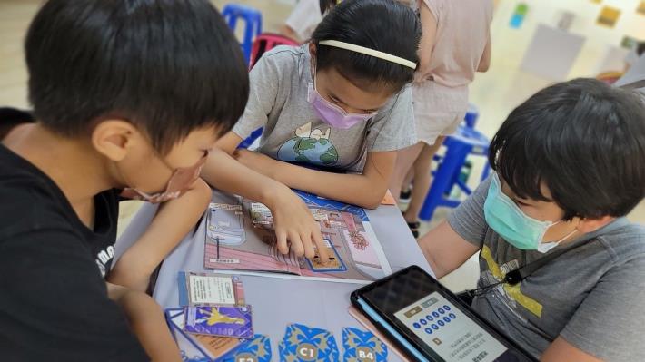 Kids playing boardgame as part of YDO's maker education course