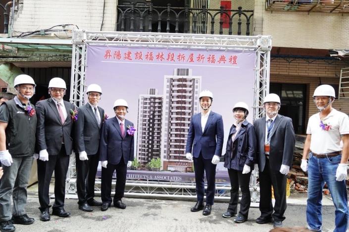 Mayor Chiang and dignitaries standing before the complex being dismantled