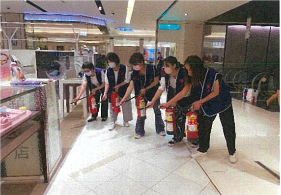 Department store employees taking part in a drill