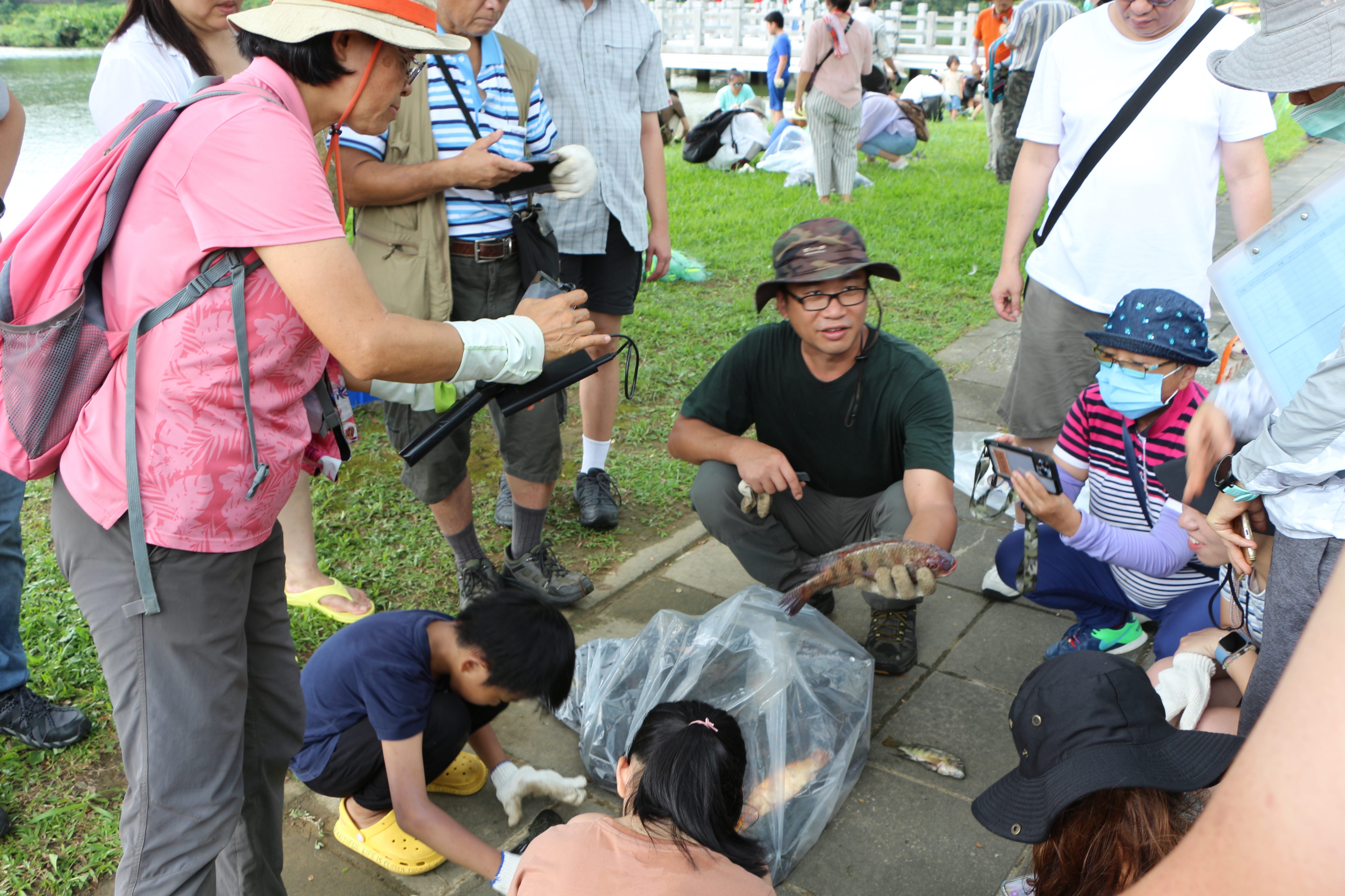 Instructor explaining details about introduced species to participants