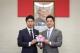 Mayor of Taipei, Wan-an Chiang, presents the 2025 Taipei City and New Taipei City World Masters Games mascot, 'Strong,' to Japanese House of Representatives Member Yasutaka Nakasone, symbolizing international sports exchange.