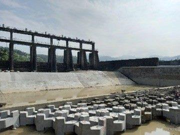 Placement of concrete armor blocks in stilling basin