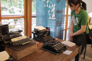 1.	A visitor takes a closer view of typewriters currently on display at Grass Mountain Chateau. (Photo courtesy of Department of Cultural Affairs, Taipei City Government)