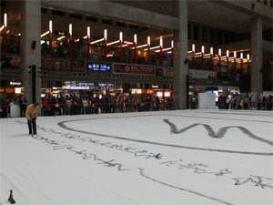 Zen master Hung Chi-sung wields the brush to ink the Chinese character for 