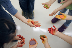Children show their hands stained with paint colors. (Photo courtesy of Taipei Fine Arts Museum)