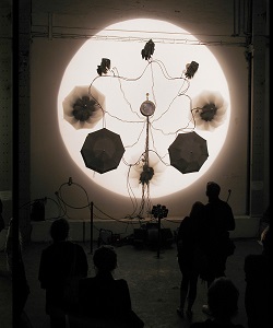 Peter William Holden uses umbrellas to create his work titled AutoGene, which looks like pistons producing a charming performance.