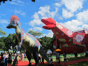 Visitors gather around with two dinosaurs to take photos. (Photo Courtesy of Taipei City