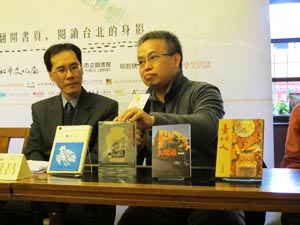 John Lin, right, one of the Taipei Literature Festival curators, shows a book titled “Taipei People” in four editions with varied book cover designs from the 1970s to the 2000s. (Photo Courtesy of Taipei Department of Cultural Affairs)