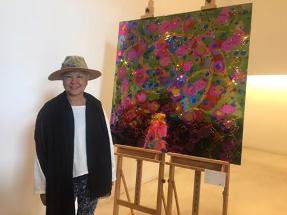  Artist  Jun  T.  Lai  poses  beside  her  artwork  exhibited  at  the  2016  TAD  Festival, Nov. 3.