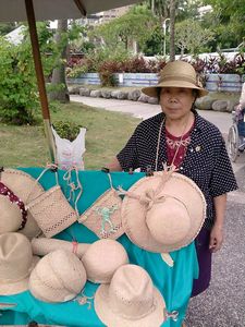 72-year-old Kuo Chen Su-chih, a master of rush grass knitting, stands in front her products Oct. 22 in Taipei Water Park as part of the 2011 Taipei Street Artists Carnival. (Photo by Psyche Cho)