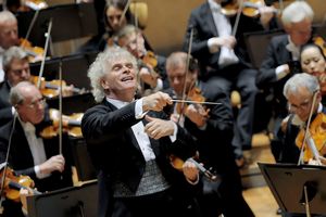 Sir Simon Rattle (front row), Chief Conductor and Artistic Director of the Berlin Philharmonic, lifts his baton to conduct the orchestra. (Photo Courtesy of MNA)