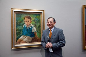 Yen Chien-feng, 3rd son of the late artist Yen Shui-long, stands in front of a portrait of himself by his father and speaks to the media at a preview press conference December 1 in Taipei. 