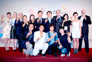 Officials and actors pose for a group photo in the opening party of Taipei Film Festival 2011 on June 24 in Taipei.