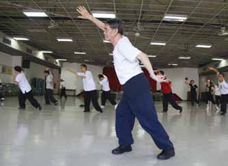1. Students intently follow the movements of their Taiji Daoyin master, Xiong Wei.