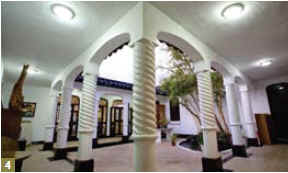 4. The traditional Eastern courtyardhouse architectural style is mixed with Western aesthetics, displaying Asian tiling and European-style curving covered gal ler ies and spiralling columns.