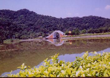 arch-shaped bridge over the lake