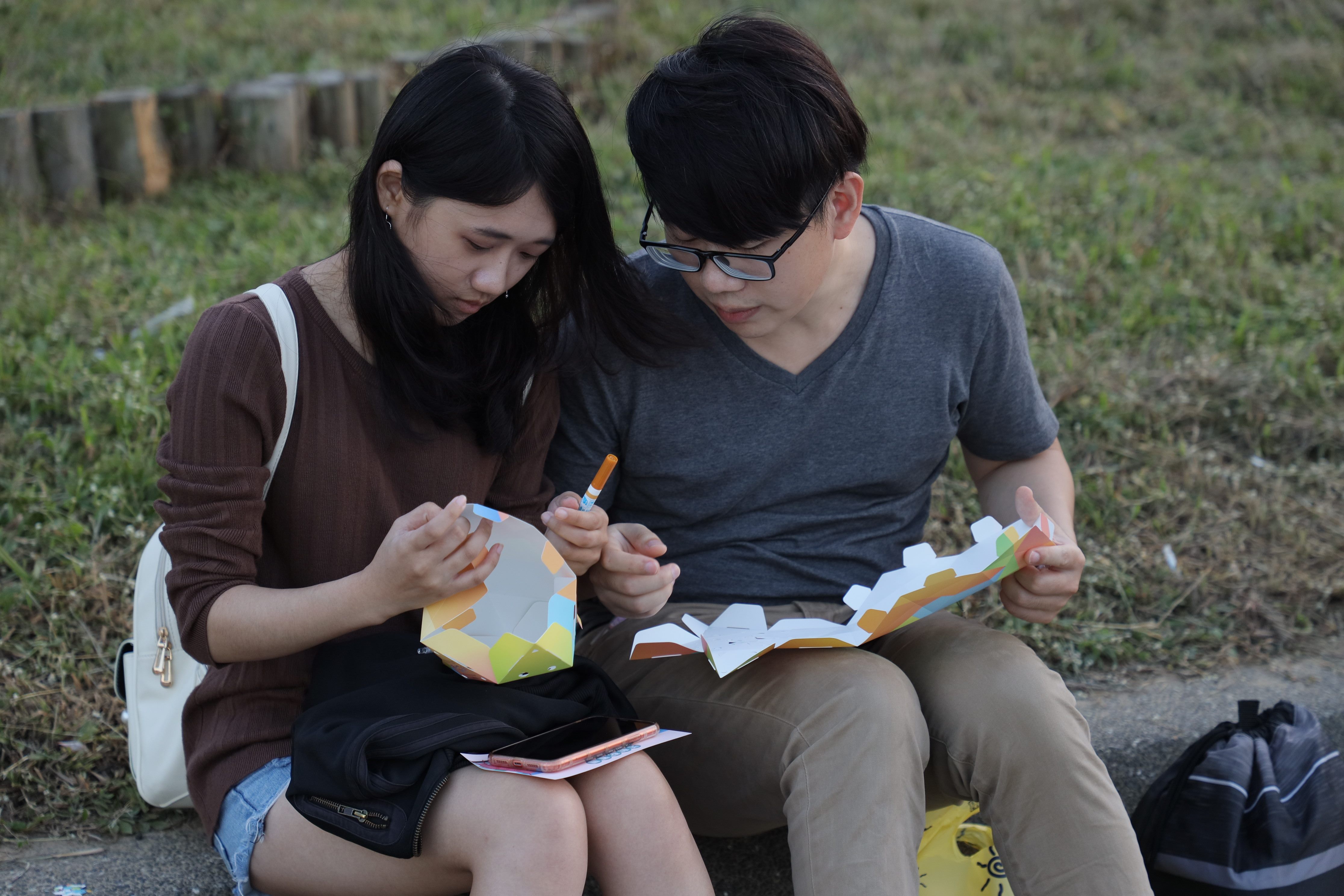 Couples making floating lanterns together