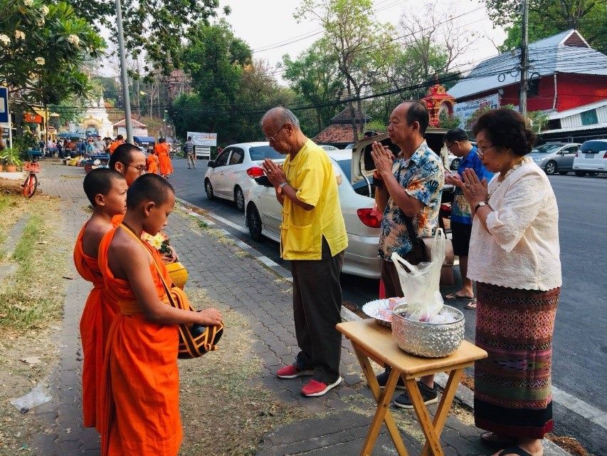 Doing good deeds in front of the temple as a family