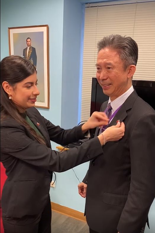 Amb. Mirna Mariela Rivera Andino Helped Amb. Chou put on the Flag pin