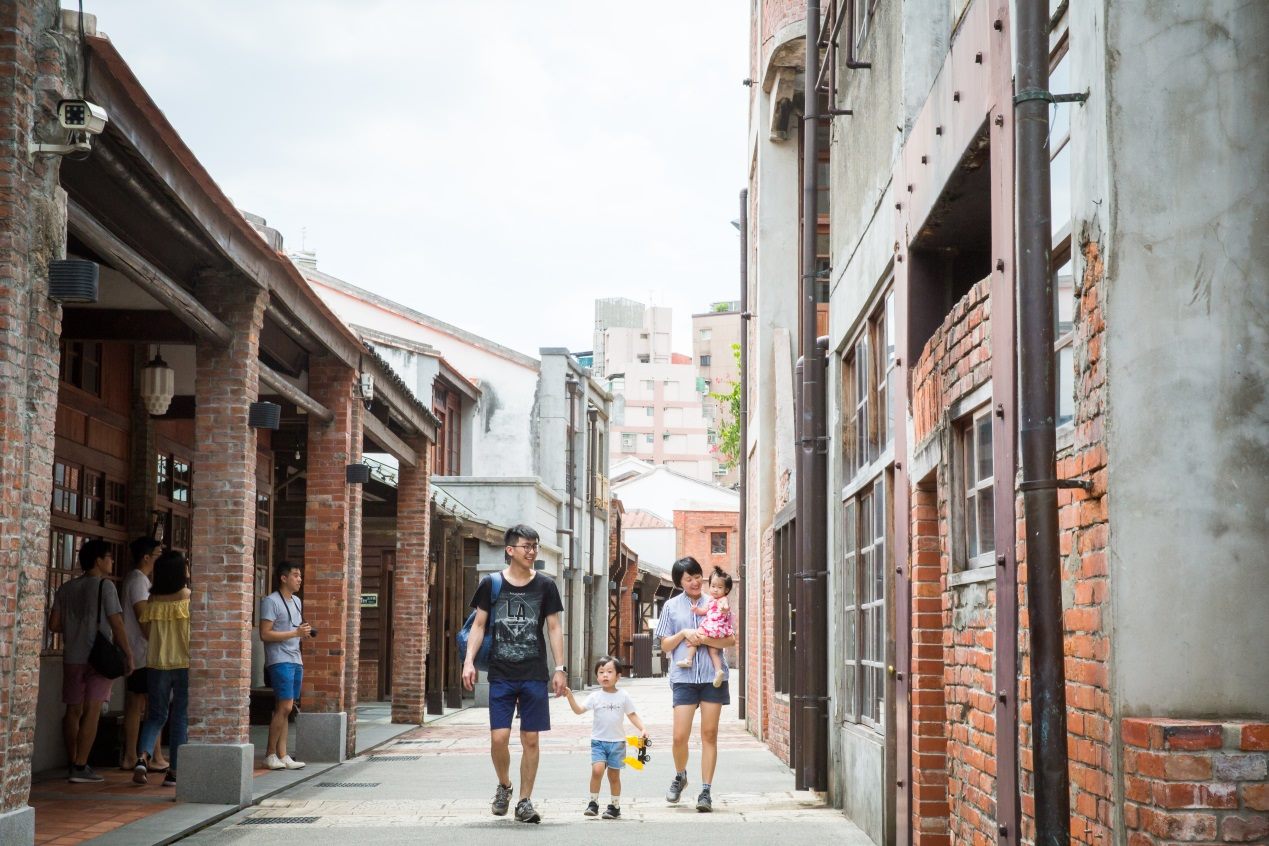 A family walks along the old street at the Bopiliao Historical Block.
