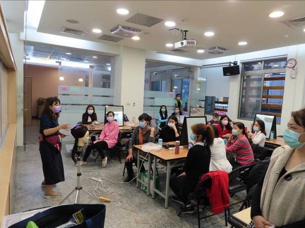 Lecturer demonstrating how to handle a head during hairdressing